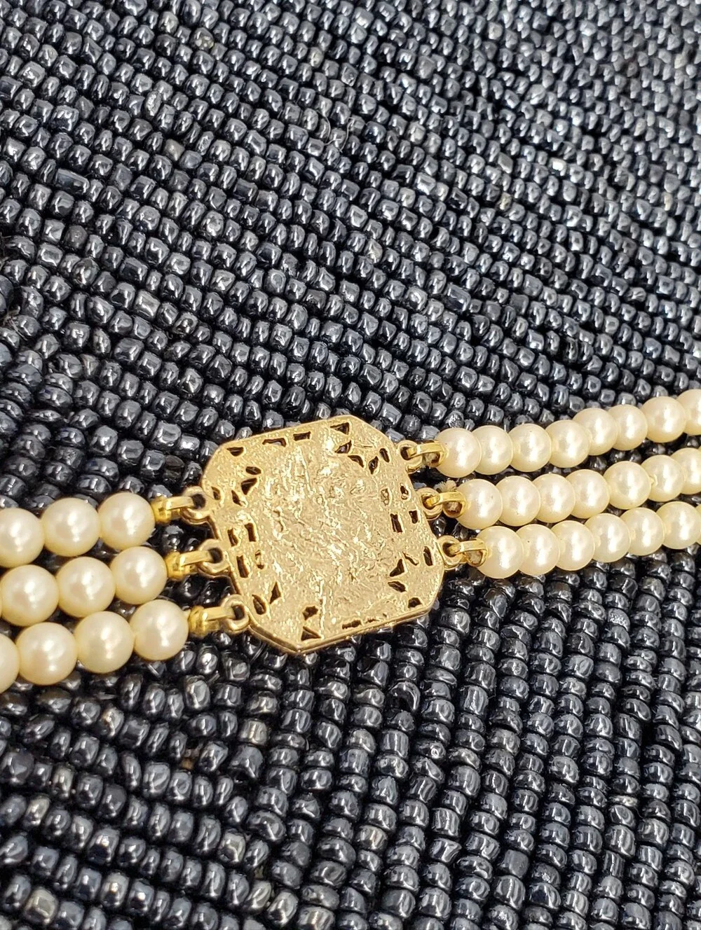 Vintage-style 3-strand pearl choker necklace with a prominent cameo centerpiece